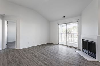 A room with a fireplace and sliding glass doors